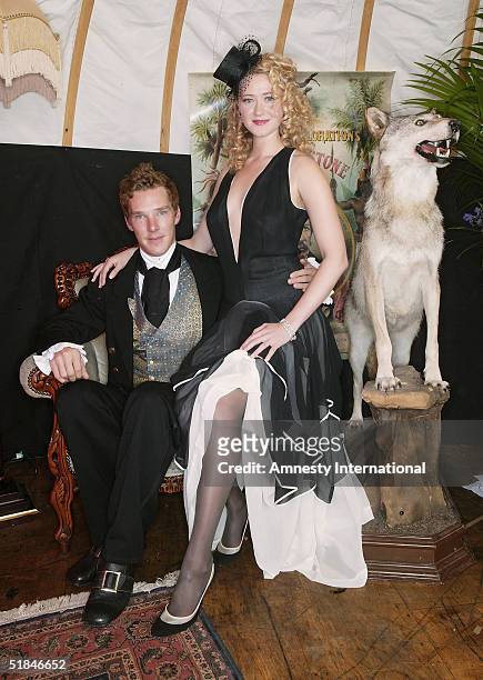 Actors Benedict Cumberbatch and Siobhan Hewlett pose in a Victorian-themed booth at the "Amnesty International - VIP Burlesque Party" at Canvas on...