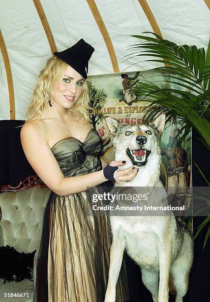 Singer Natasha Bedingfield poses in a Victorian-themed booth at the "Amnesty International - VIP Burlesque Party" at Canvas on November 25, 2004 in...