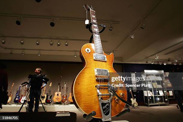 Guitar, once owned and used by Keith Richards of the Rolling Stones, stands on display at Christie's December 10, 2004 in New York City. Christie's,...