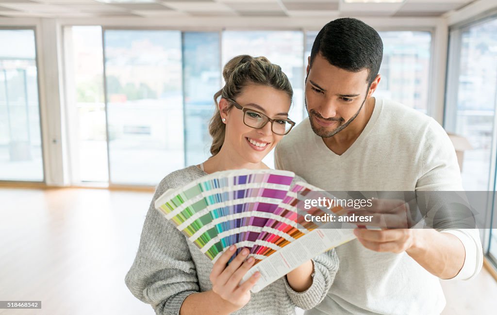 Couple painting their house