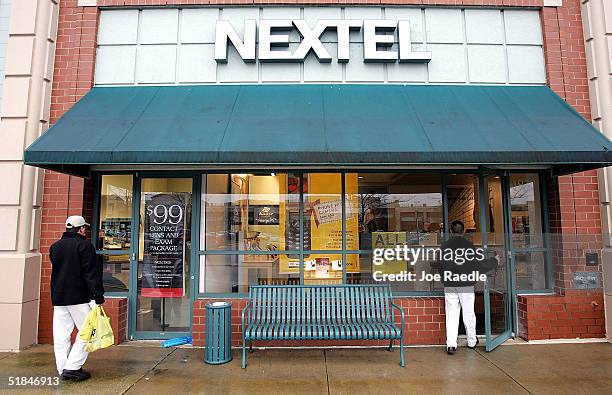 Customers walk into a Nextel store December 10, 2004 in Reston, Virginia. Reports say that wireless service providers Sprint and Nextel are in...