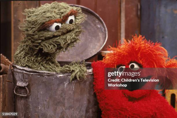 Muppet visits 'Oscar the Grouch' at his garbage can in a scene from 'Sesame Street,' circa 1985.