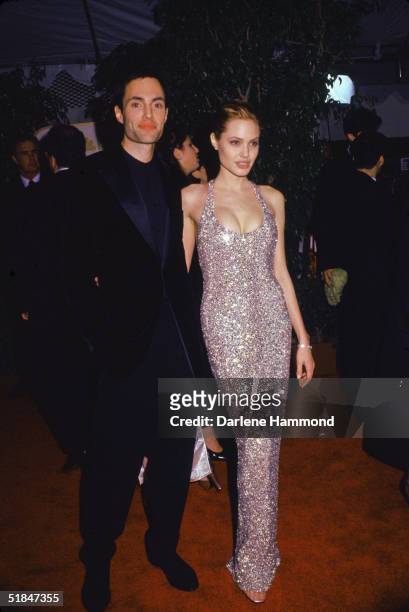 American actress Angelina Jolie with her brother, American actor James Haven, at the 56th Annual Golden Globe Awards, where Jolie won the award for...