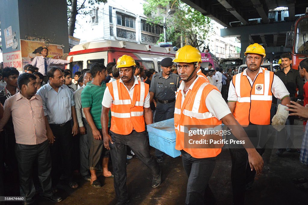 Rescuers on the go of rescuing victims at the collapsed...