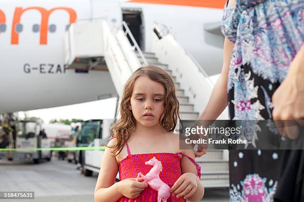 young girl at the gangway holding here toy horse - airplane gangway stock pictures, royalty-free photos & images
