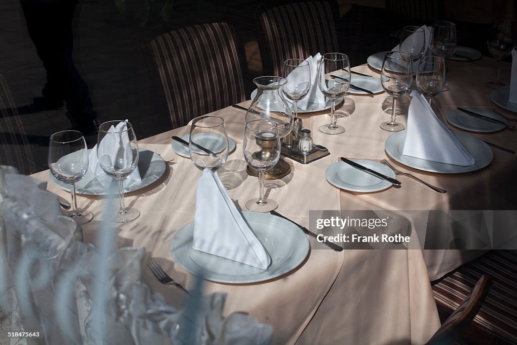 Nicely laid table with dishes and glasses