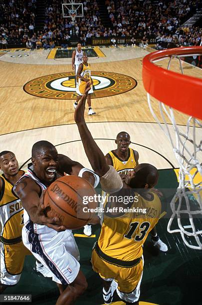 Eric Williams of the New Jersey Nets takes the ball to the basket against Jerome James of the Seattle Sonics during the game at Key Arena on November...