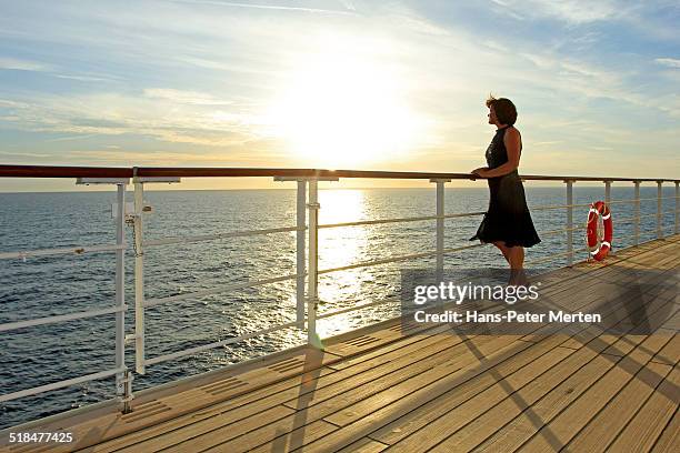 dressed up woman on deck of a cruise ship - bateau croisiere photos et images de collection
