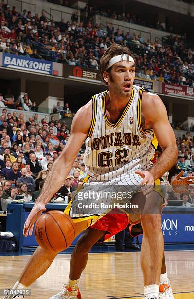 Scot Pollard of the Indiana Pacers moves the ball against the Charlotte Bobcats during the game at Conseco Fieldhouse on November 26, 2004 in...