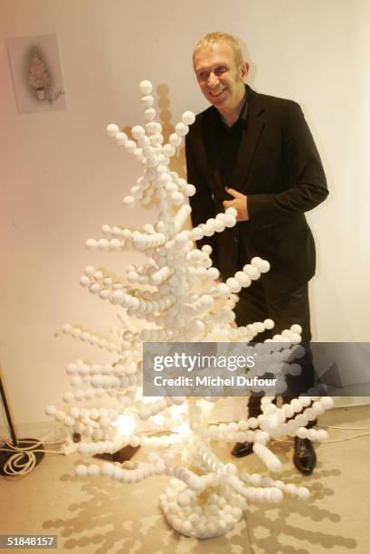 Jean Paul Gaultier poses with his tree at a private party featuring christmas trees created by fashion designers held at the Centre Pompidou December...