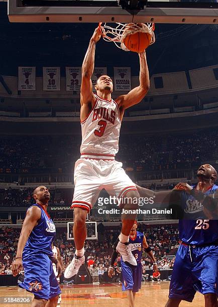 Tyson Chandler of the Chicago Bulls slams the ball for two points against Marc Jackson of the Philadelphia 76ers during a game on December 10, 2004...