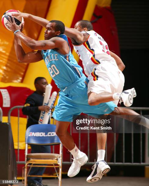 Brandon Knight of the Asheville Altitude drives to the basket against Bernard King of the Huntsville Flight on December 10, 2004 at the Von Braun...