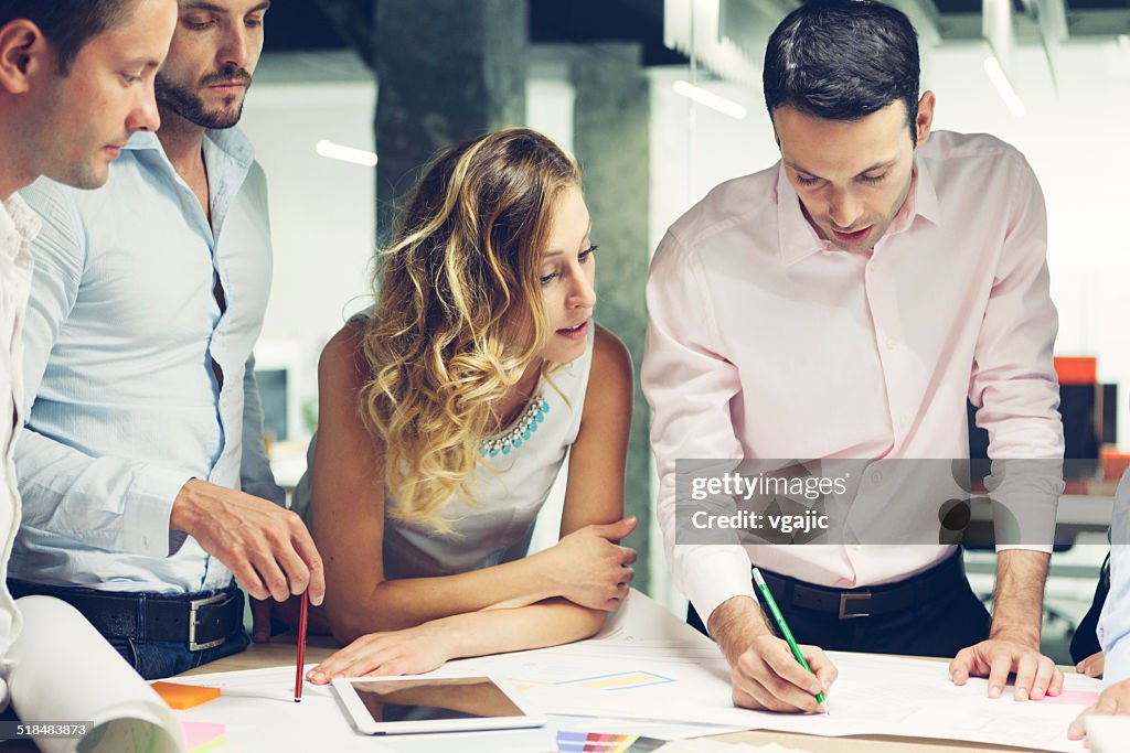 Group of Young Designers reviewing new project in the office.