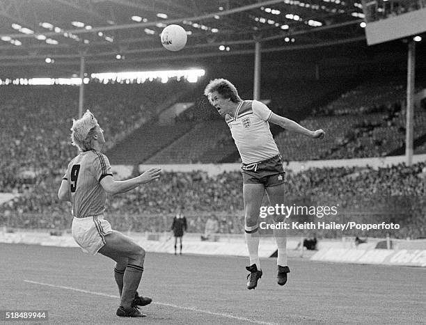 Phil Neal of England heads over Wim Kieft of Holland during the International match between England and Holland at Wembley Stadium in London on the...