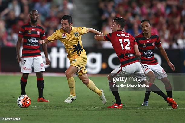 Luis Garcia of the Mariners takes the ball past defender Scott Neville of the Wanderers during the round 26 A-League match between the Western Sydney...