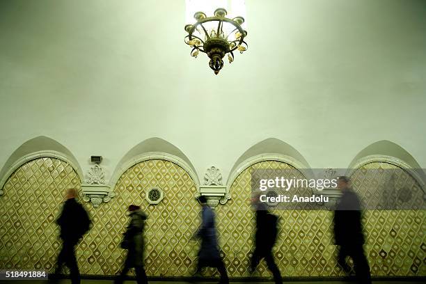 Passengers are seen walking past in front of the wall reliefs at the Komsomolskaya Metro Station in Moscow, Russia on April 01, 2016. The Moscow...