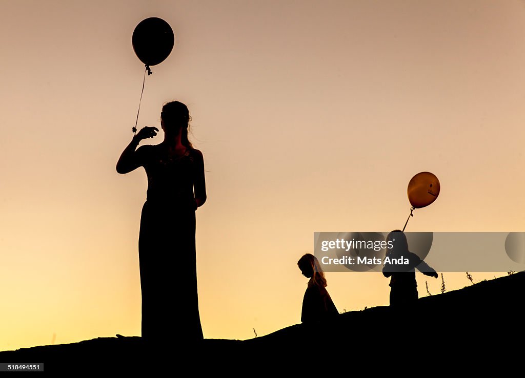 Silhouetted family of three