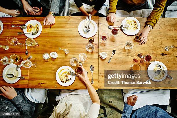 overhead view of friends at table during party - acabar imagens e fotografias de stock