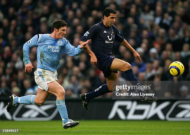 Noureddine Naybet of Tottenham Hotspur beats Jon Macken of Manchester City during the Barclays Premiership match between Manchester City and...