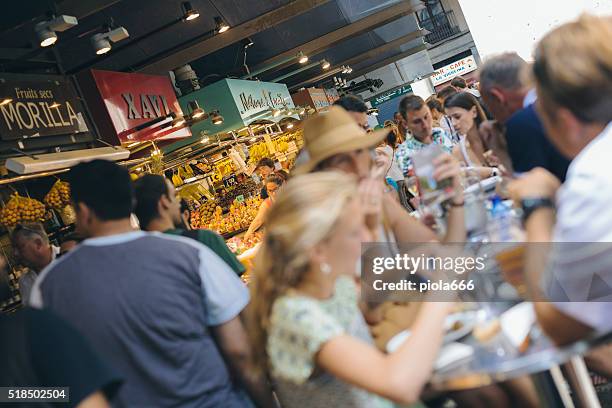 people eating at the boqueria market in barcelona - barcelona tapas stock pictures, royalty-free photos & images