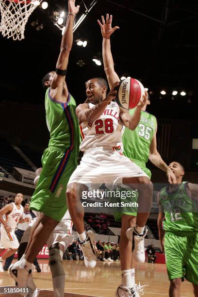 Ed Scott of the Huntsville Flight makes the assist against Kirk Haston of the Florida Flame on December 11, 2004 at the Von Braun Center in...