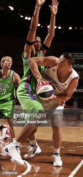 Mengke Bateer of Huntsville Flight stretches to get around the defense of the Florida Flame on December 11, 2004 at the Von Braun Center in...