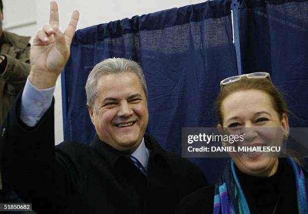 Romanian Prime Minister Adrian Nastase , the presidential candidate on behalf of PSD+PUR alliance makes the victory sign together with his wife Dana...