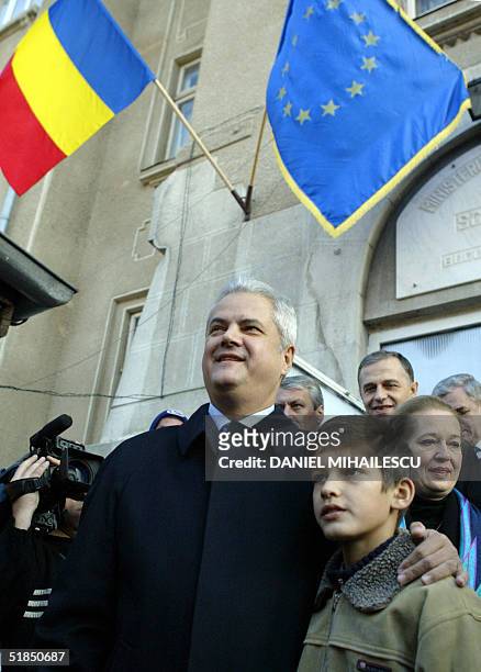 Romanian Prime Minister Adrian Nastase , the presidential candidate on behalf of PSD+PUR alliance holds his youngest son, Mihnea at the exit from a...