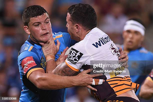 Ash Taylor of the Titans tackles Darius Boyd of the Broncos during the round five NRL match between the Gold Coast Titans and the Brisbane Broncos at...