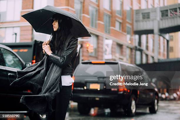 Model Diana Galimullina wears all black and waits for a taxi in the rain after the Ohne Titel show at Sixty Ten during New York Fashion Week: Women's...