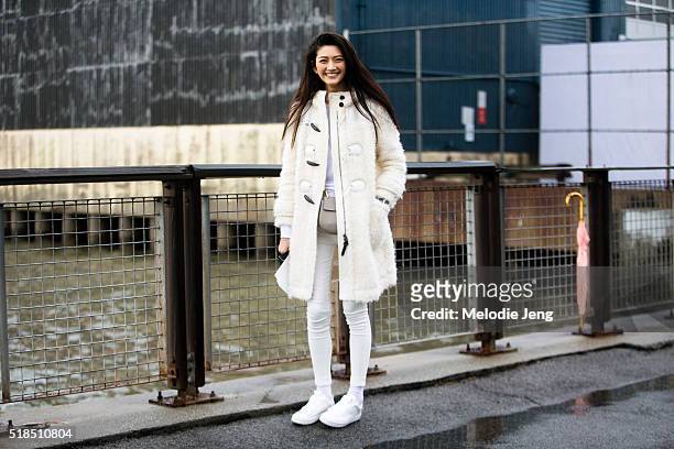 Taiwanese model I-Hua Wu attends the Coach show in an all white outfit including a toggle shearling coat, skinny jeans, canvas sneakers, and a Chloe...
