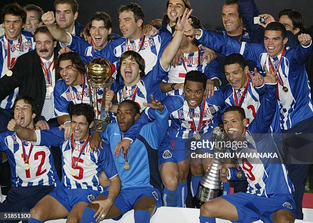 Portugese Club FC Porto players celebrate their victory as they display the Intercontinental Cup and the Toyota Cup after winning against Colombian...