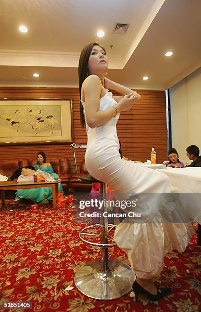 Contestants take a break after a news conference promoting the first Miss Plastic Surgery on December 12, 2004 in Beijing, China. 19 contestants...