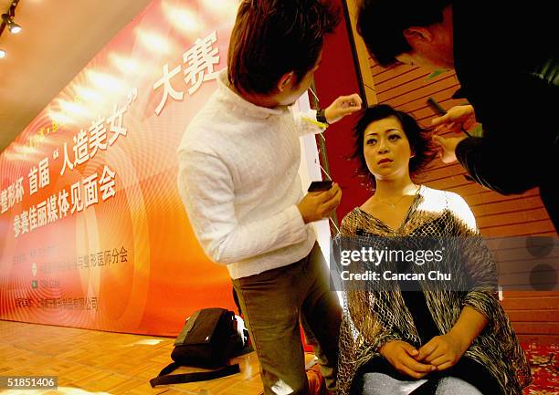 Yi Xin, a 20 year-old contestant, prepares for a news conference promoting the first Miss Plastic Surgery on December 12, 2004 in Beijing, China. 19...