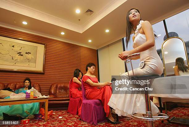 Contestants take a break after a news conference promoting the first Miss Plastic Surgery on December 12, 2004 in Beijing, China. 19 contestants...