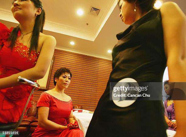 Contestants take a break after a news conference promoting the first Miss Plastic Surgery on December 12, 2004 in Beijing, China. 19 contestants...