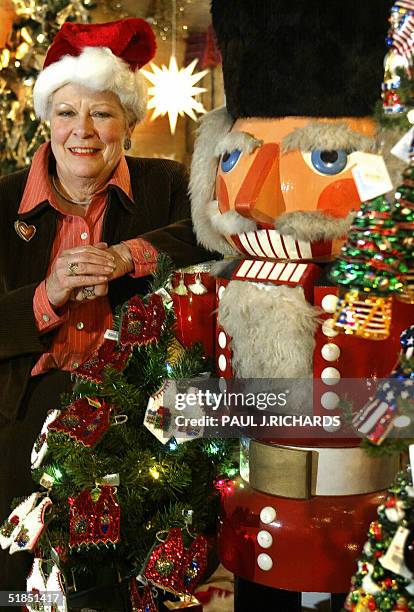 Nita Whitesel, founder of the year-round Christmas decoration store called "The Christmas Store" in Alexandria, Virginia, stands by a large...