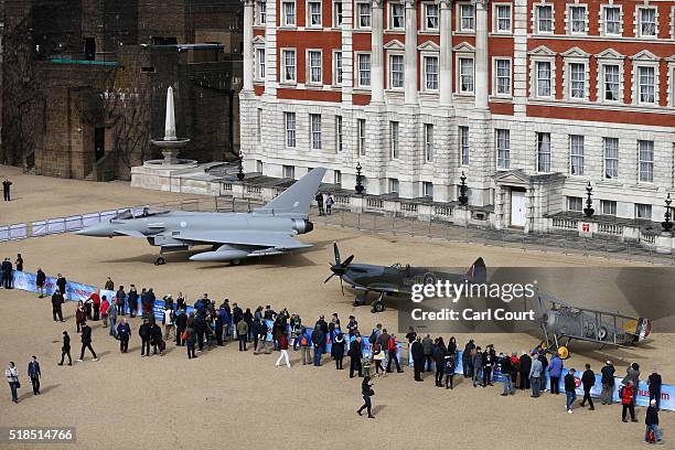 Members of the public view a full-scale replica of a Eurofighter Typhoon , a World War 2 Spitfire Mk XVI and a Sopwith Snipe as they are displayed at...