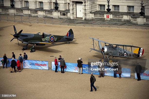 Members of the public view a World War 2 Spitfire Mk XVI and a Sopwith Snipe as they are displayed at Horse Guards Parade on April 01, 2016 in...