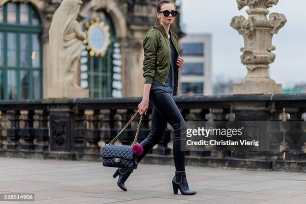 Fashion Blogger Barbora Ondrackova wearing, black Celine sunglasses, an olive green bomber jacket from Topshop, a grey tshirt from Mango, black...
