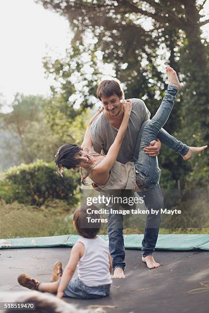 boy with parents in trampoline - crazy dad stock pictures, royalty-free photos & images