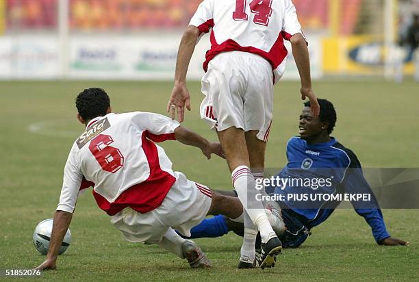 Two Etoile Sahel defenders Ahmed Hammi and Kais Zouaghi stops Enyimba's David Tyavkase from advancing into its hafh 12 December, 2004 during the CAF...