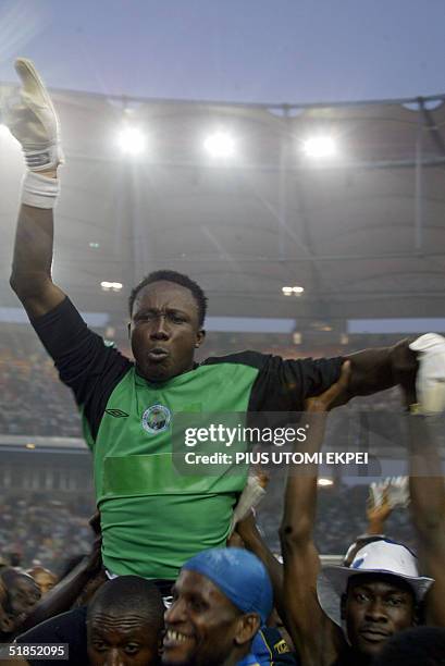 Enyimba fans carry goalkeeper Dele Aiyenugba who saved one of the penalties taken by Etoile d' Sahel 12 December, 2004 during the CAF Cup final match...