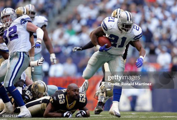 Running back Julius Jones of the Dallas Cowboys runs past Roger Knight of the New Orleans Saints on December 12, 2004 at Texas Stadium in Irving,...