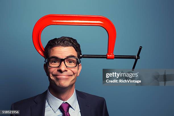 adult businessman smiling with vice on his head - clamp stock pictures, royalty-free photos & images