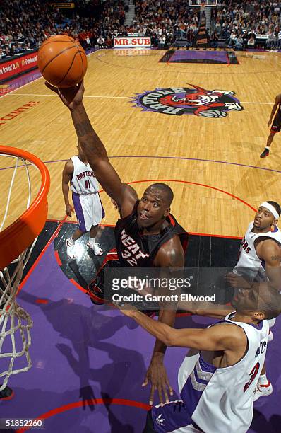 Shaquille O'Neal of the Miami Heat goes to the basket against Loren Woods of the Toronto Raptors on December 12, 2004 at Air Canada Centre in...