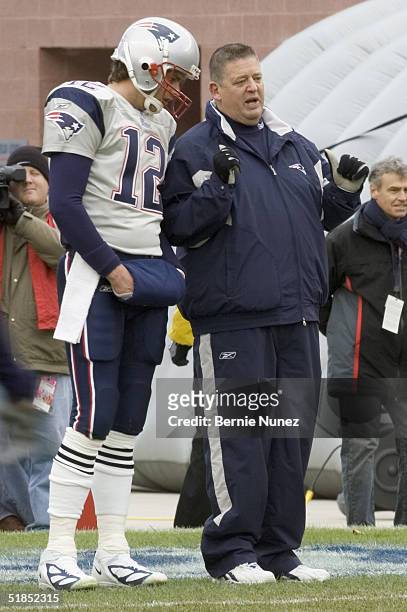 Offensive coordinator Charlie Weis and Tom Brady of the New England Patriots talk prior to the game against the Cincinnati Bengals at Gillette...