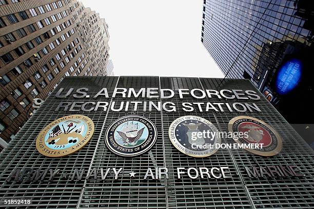 The emblems of the four branches of the US armed forces are seen on the military recruiting station in New York's Times Square 09 December 2004....