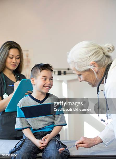 hispanic boy's pediatrician visit, reflexes - reflex hammer stock pictures, royalty-free photos & images