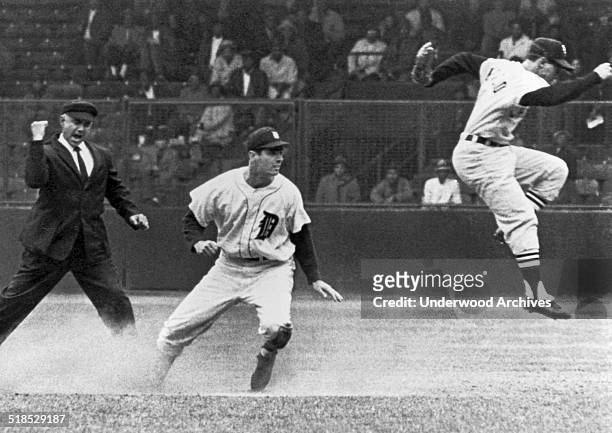 Detroit's Rocky Colavito is called out at second by umpire Sam Carrigan as Chicago White Sox shortstop Luis Aparicio leaps out of the way after...